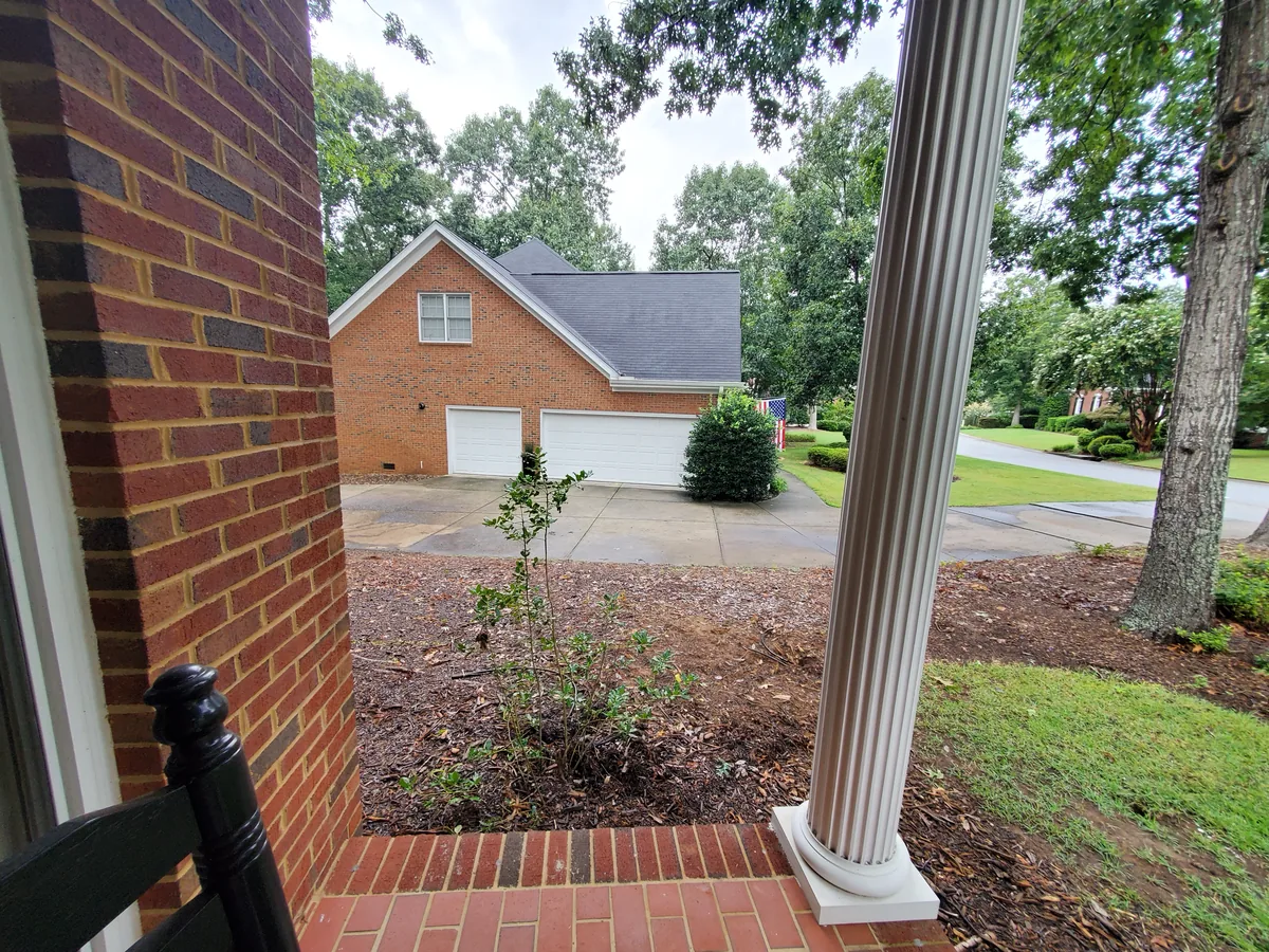 SolomonsLandscape landscape boiling springs sc - Solomon's Landscape & Design Front yard landscaping with newly planted shrub and mulch bed facing brick garage and driveway.